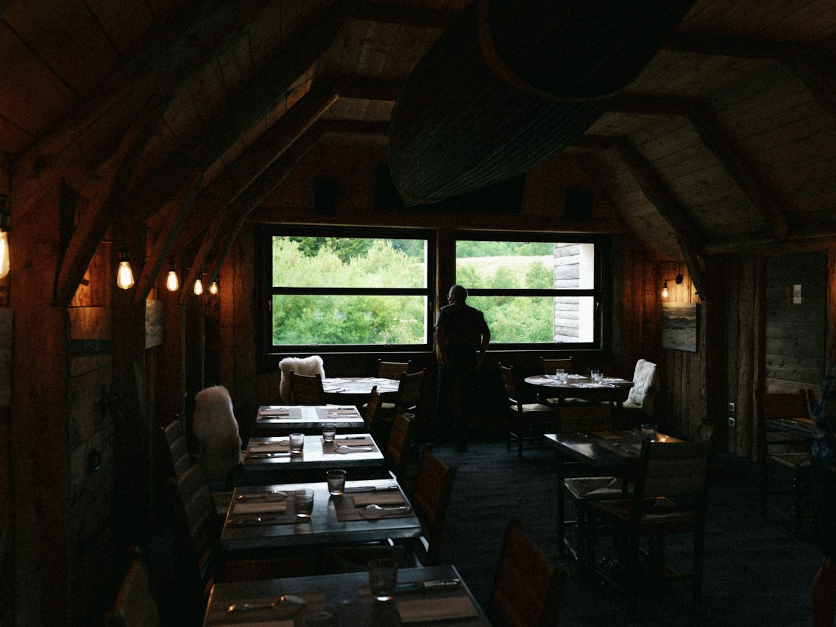 The dining room today, under the old pitched roof and beams, set for the evening.