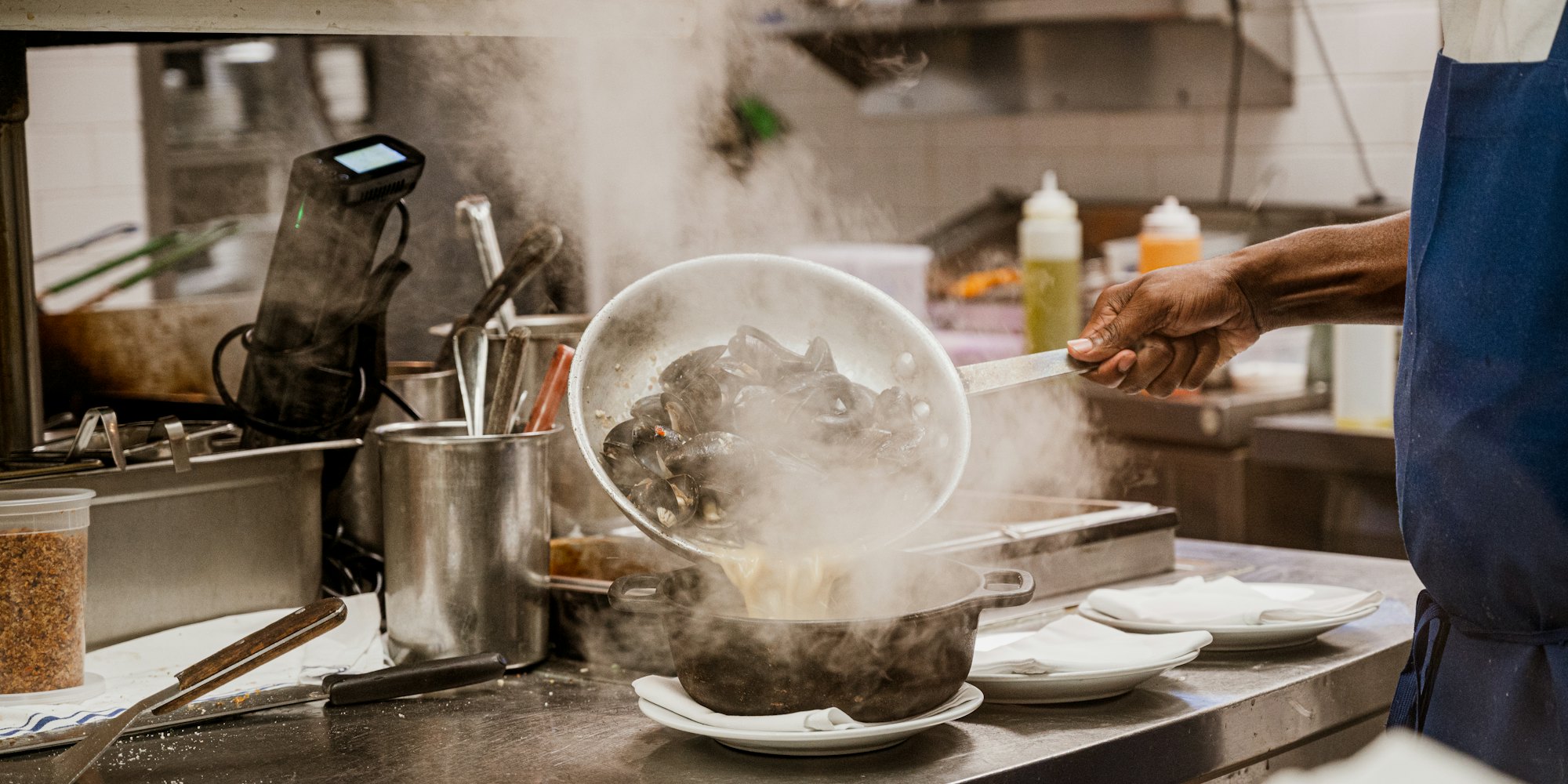 Steam rising off the pots on the line during prep.