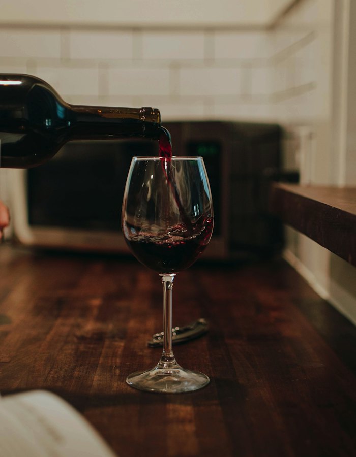 An empty wine glass on a wooden table.